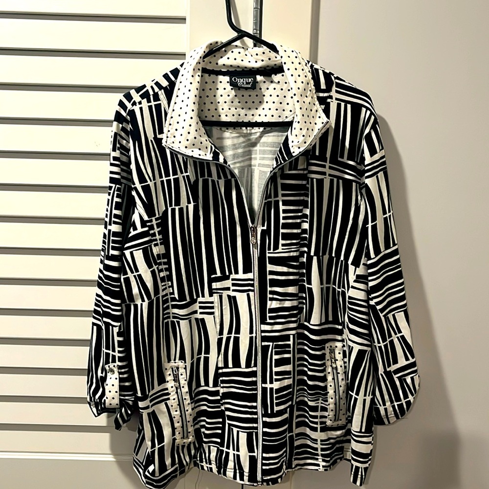 Black and white zipper front jacket with front pockets.